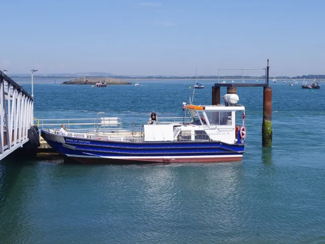 The Pride of Hayling moored at the Eastney pontoon, looking across Langstone Harbour towards Hayling Island